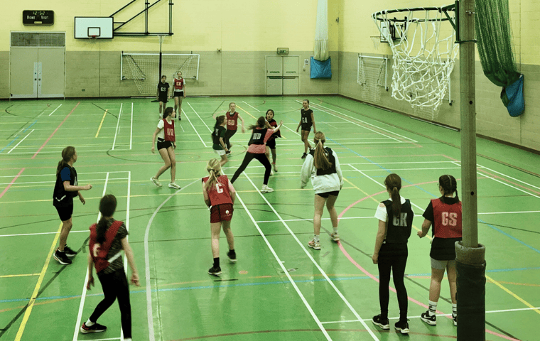 children throwing netball in the air